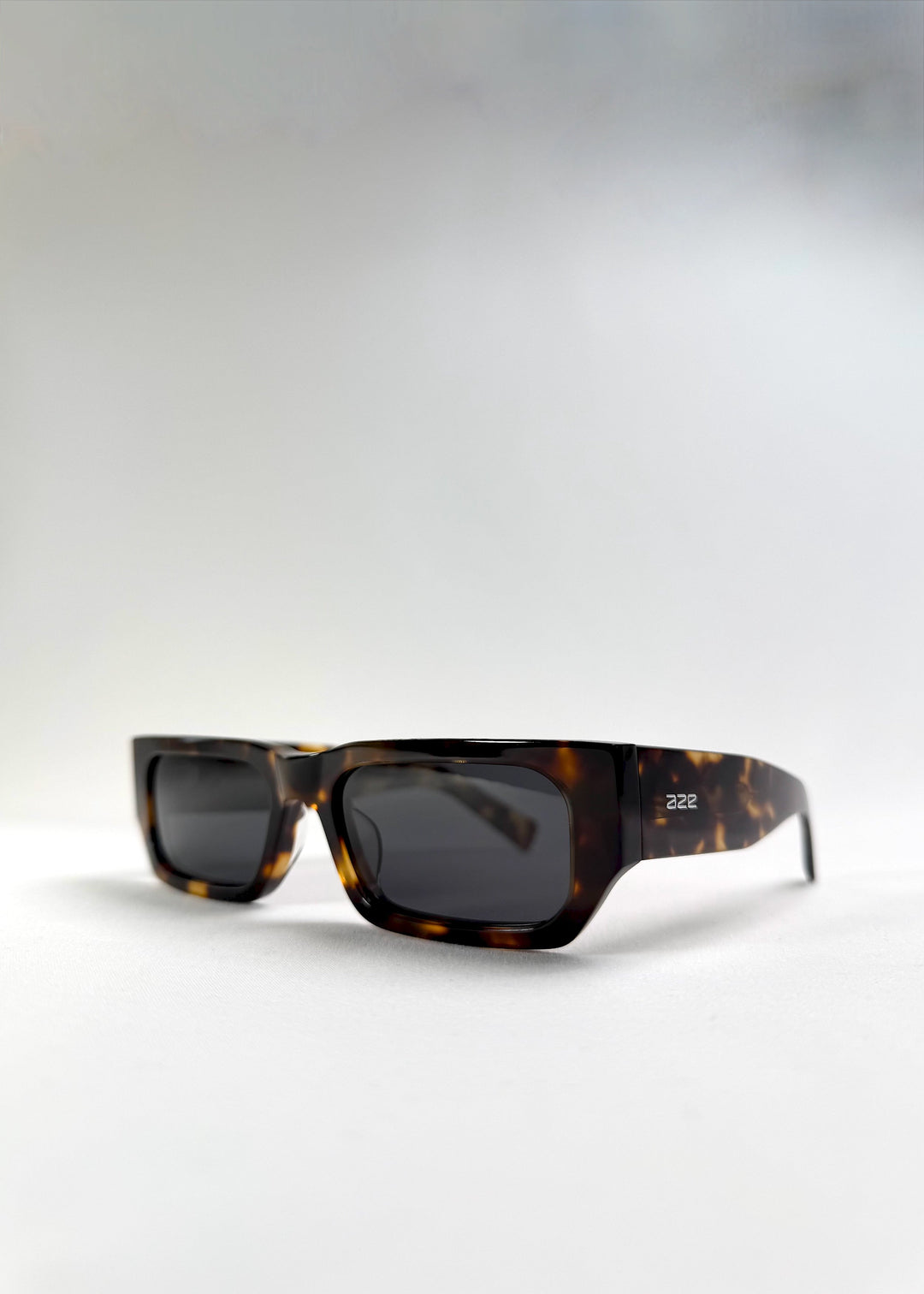 Angled front view of Oblivion Trace in Tortoise, highlighting the sharp silhouette and warm tortoiseshell tones. 