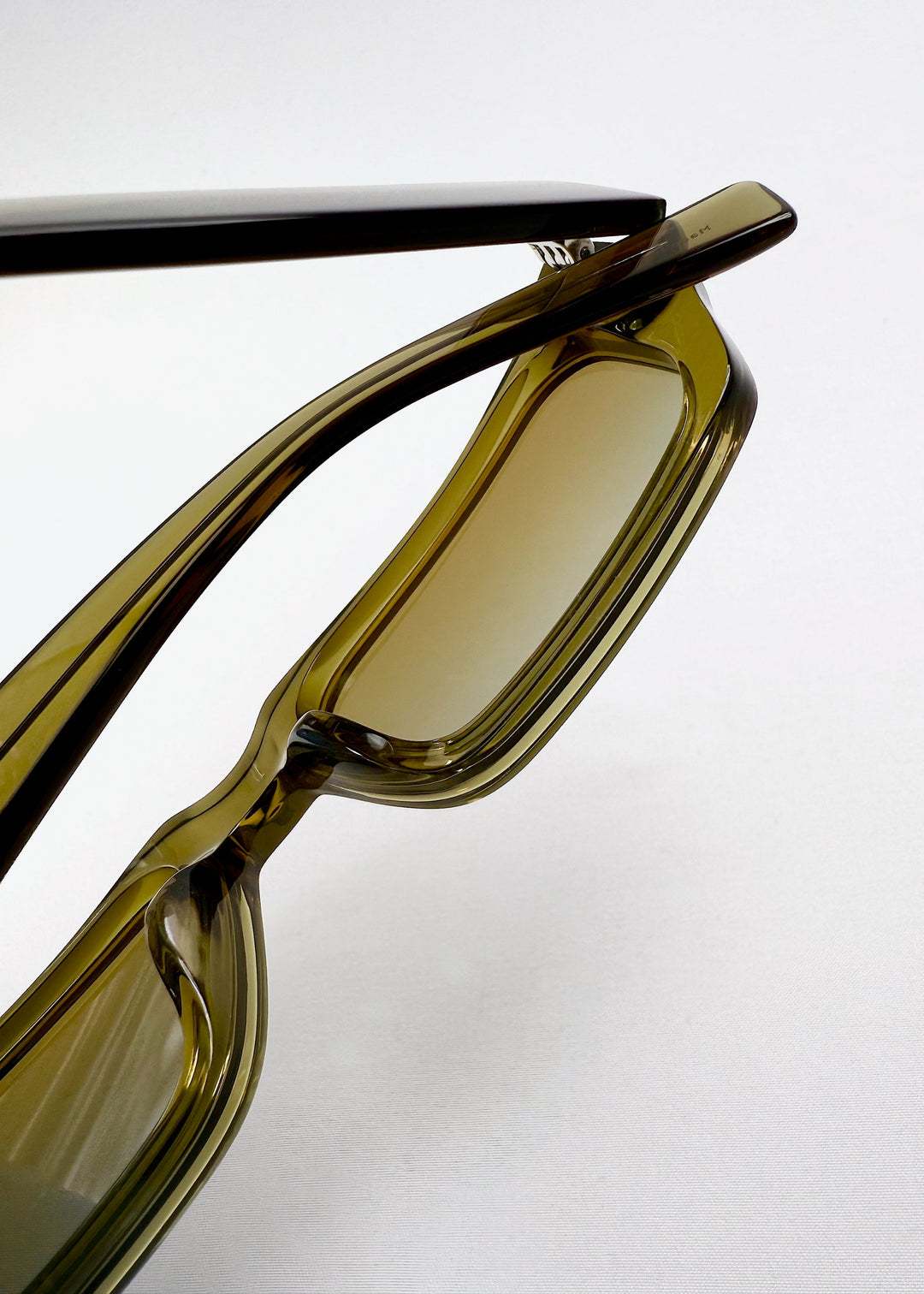 Detail shot of nose bridge and lens structure on Oblivion Trace - Verdant Gold frame, emphasizing geometric design. 