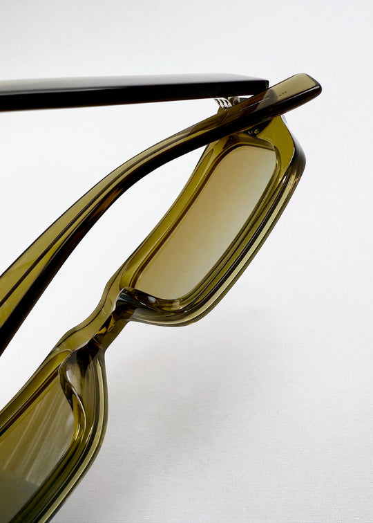Detail shot of nose bridge and lens structure on Oblivion Trace - Verdant Gold frame, emphasizing geometric design. 