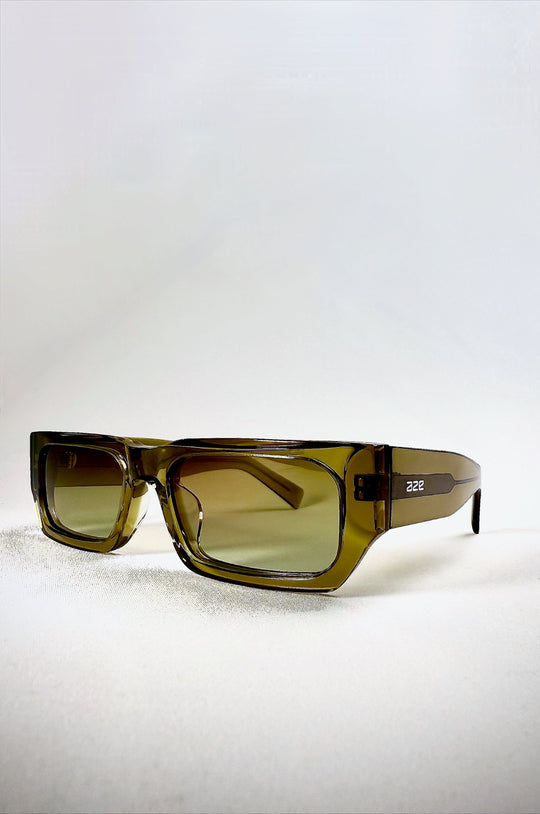 Oblivion Trace sunglasses in Verdant Gold, acetate frame viewed from front angle with translucent green tone. 