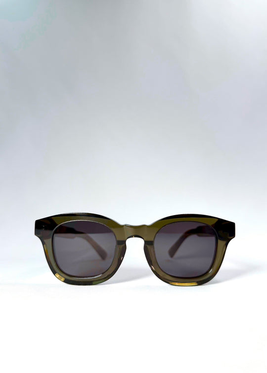 Front view of Phantom Verge sunglasses in Ash Tortoise, showing the softly rounded translucent frame and dark polarized lenses. 