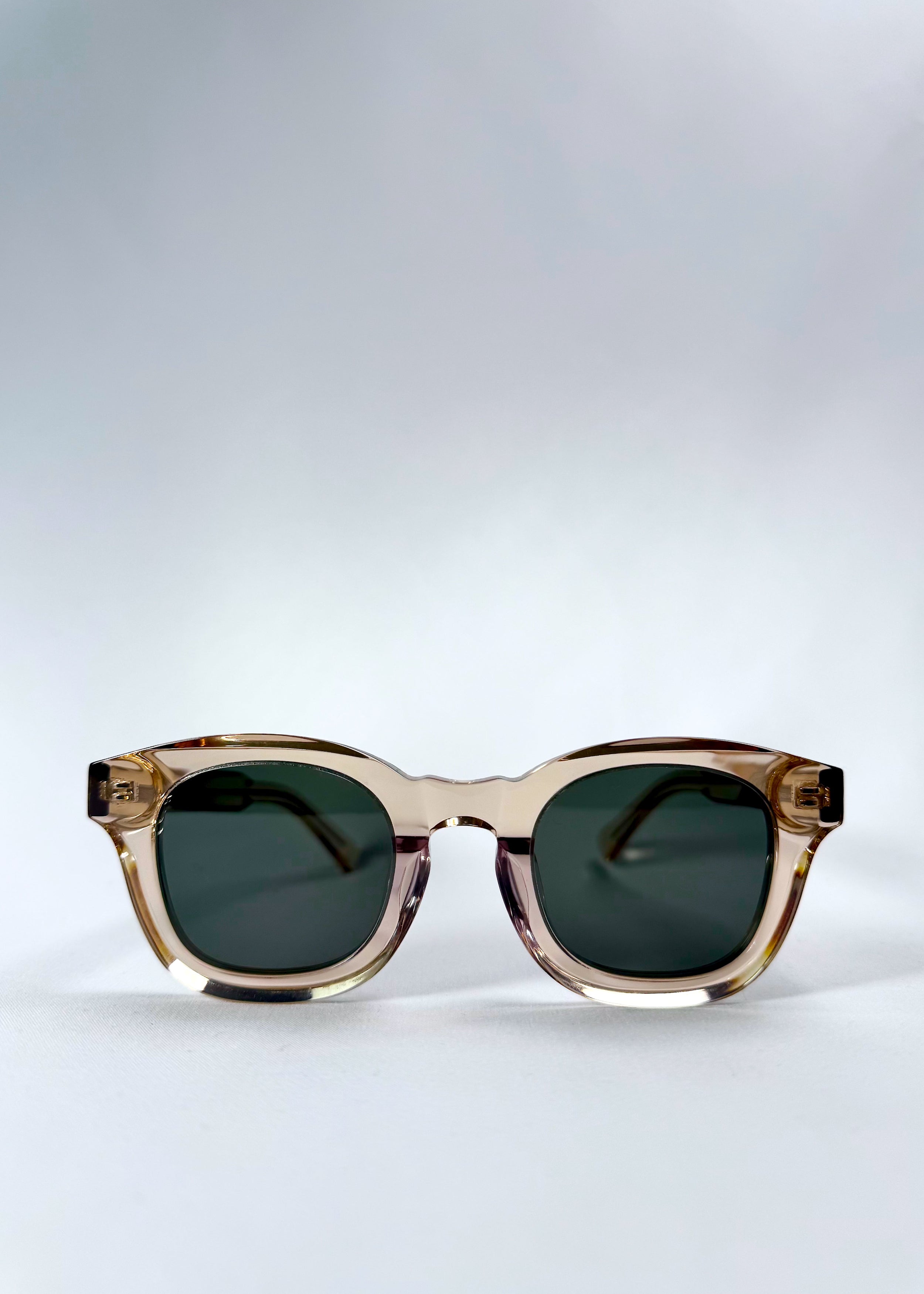 Front view of Phantom Verge in Champagne Moss showing its rounded frame and soft green lenses, ideal for petite face sizes.