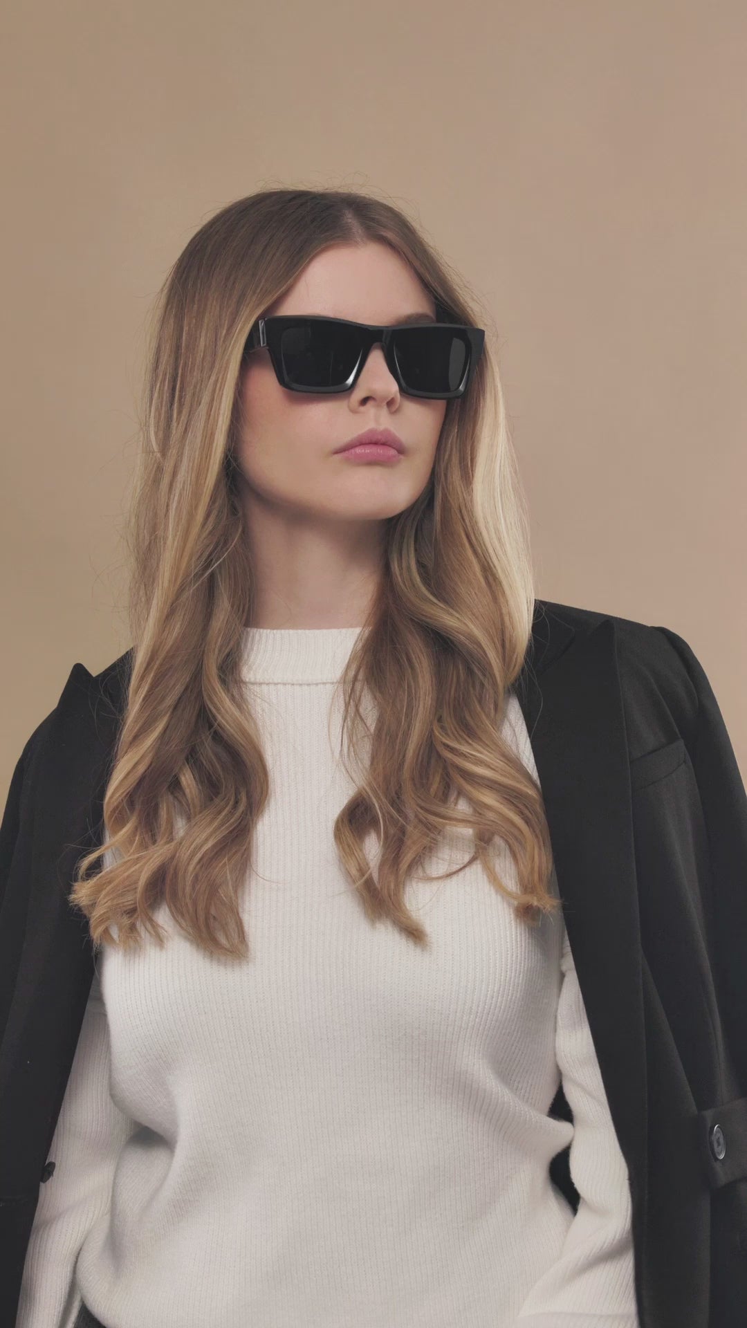 Lifestyle video of a female model wearing Fomalhaut black acetate prescription sunglasses. 