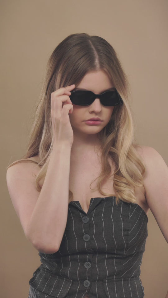 Lifestyle video of a model wearing Castor sunglasses in Black. 