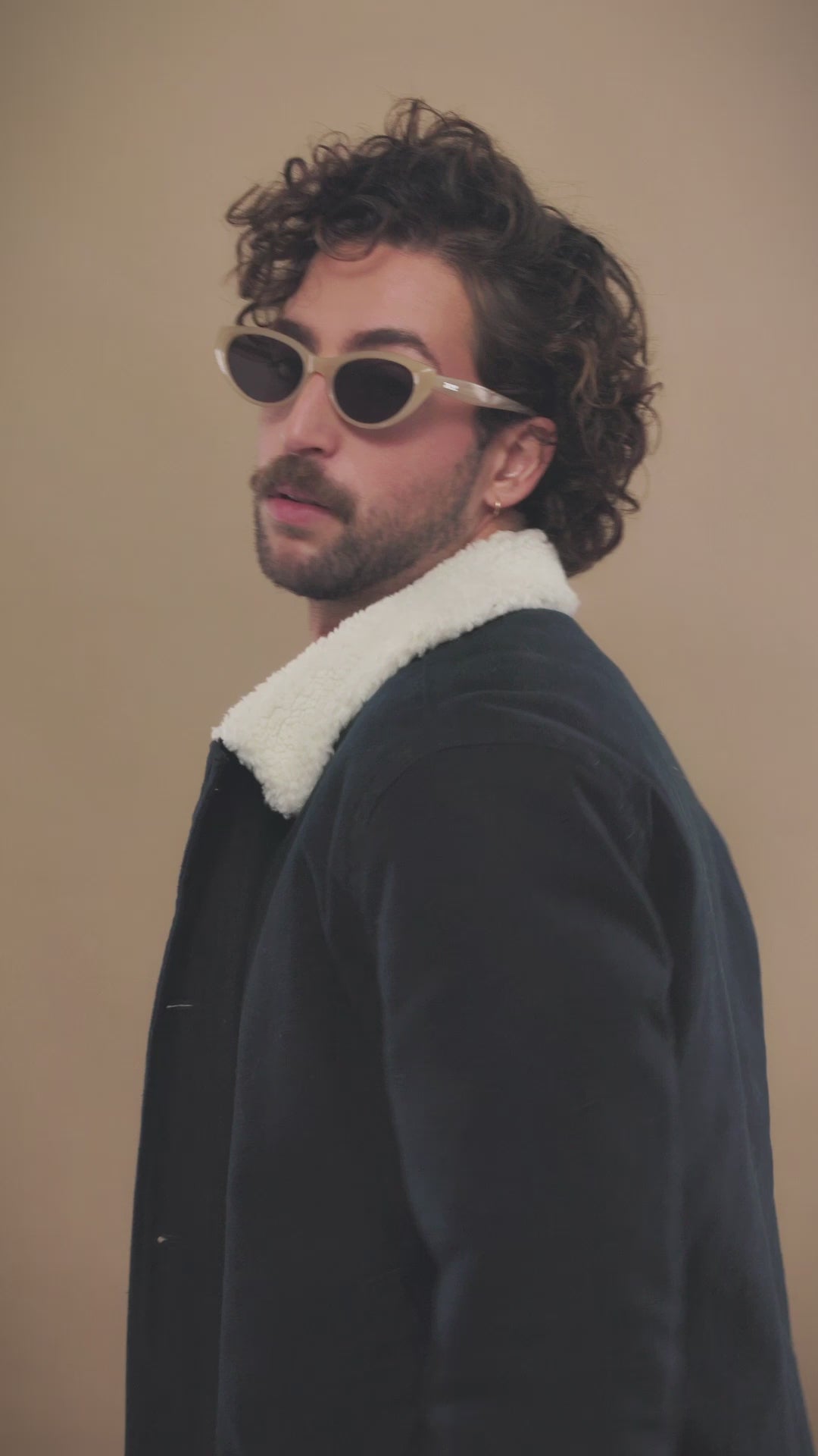 Lifestyle video of a male model wearing Chara sunglasses in Milky White. 