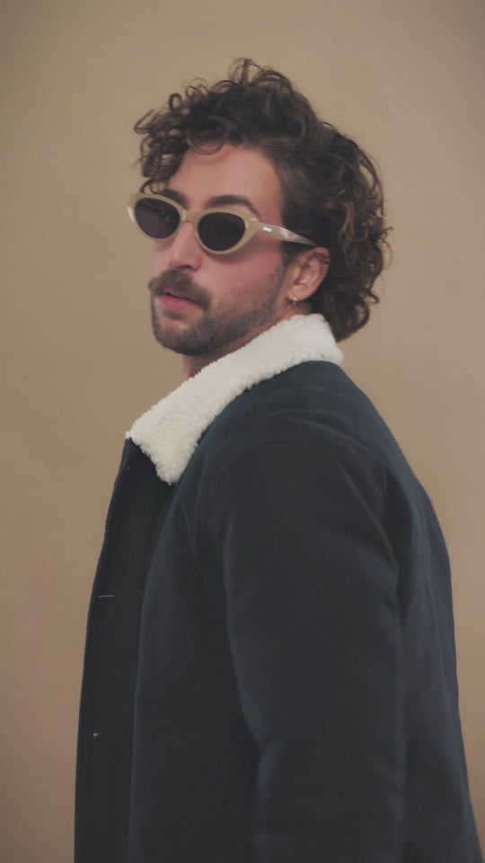 Lifestyle video of a male model wearing Chara sunglasses in Milky White. 