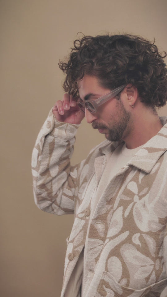 A male model wearing Castor Champagne sunglasses, showcasing the luxurious acetate frame and stylish gradient lenses. 