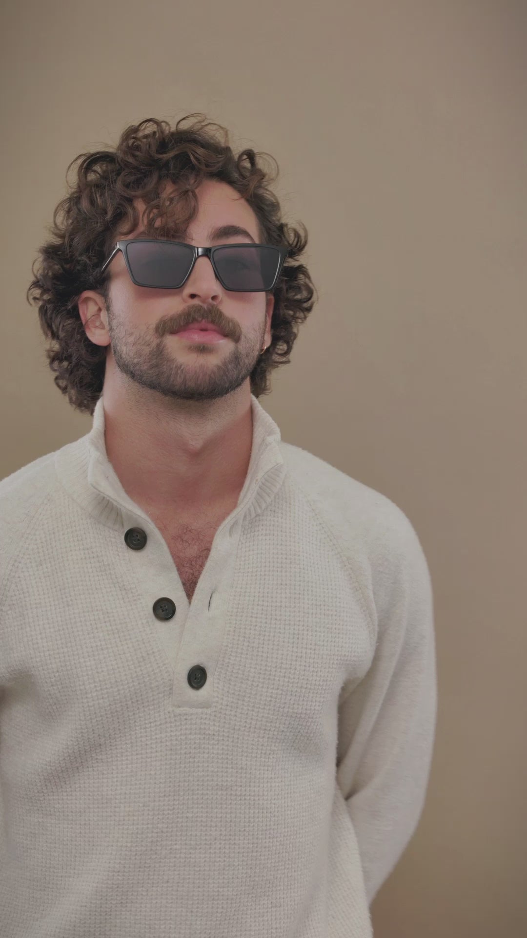 Video of male model wearing Rho Black sunglasses, showcasing a confident and effortless look. 