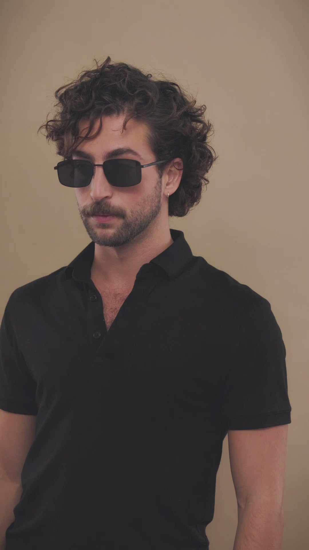 Video of a male model wearing Sirius A - Semi-Matte Black sunglasses, exuding modern sophistication and confidence. 