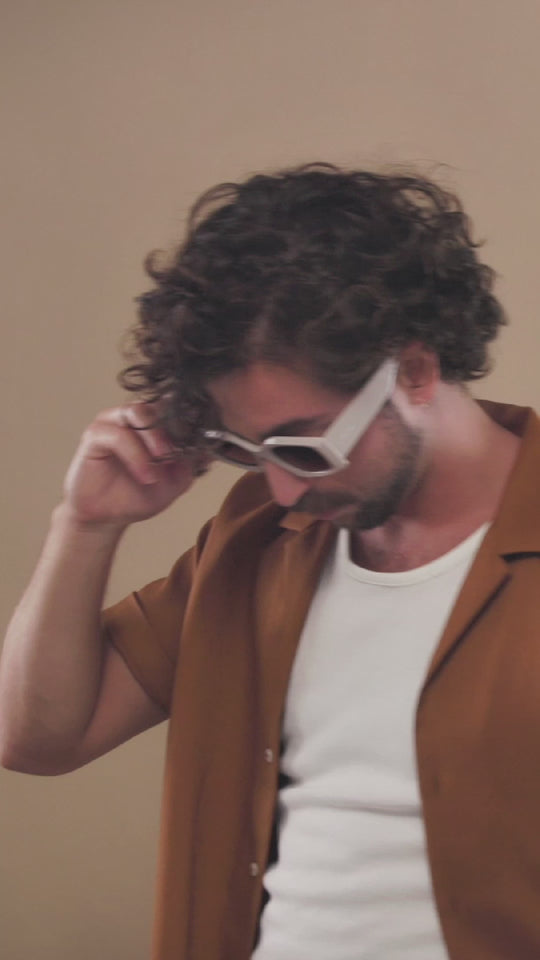 Lifestyle video of a model wearing Bellatrix sunglasses in Warm Taupe. 