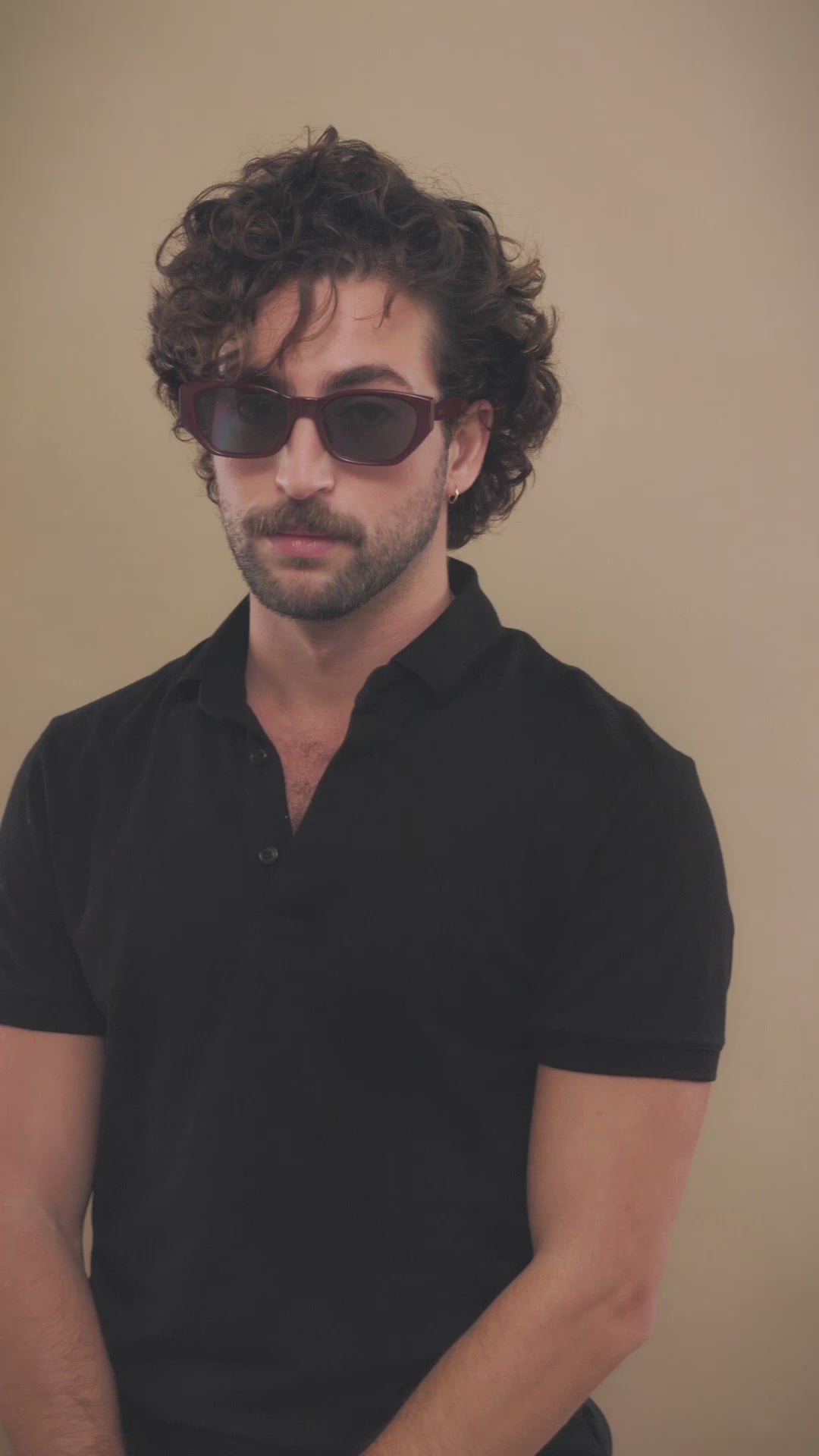 Lifestyle video of a male model wearing Mirach sunglasses in Burgundy. 