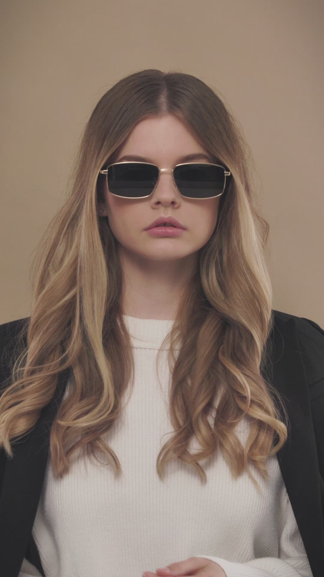 Lifestyle video of a model wearing Sirius A sunglasses in Gold. 