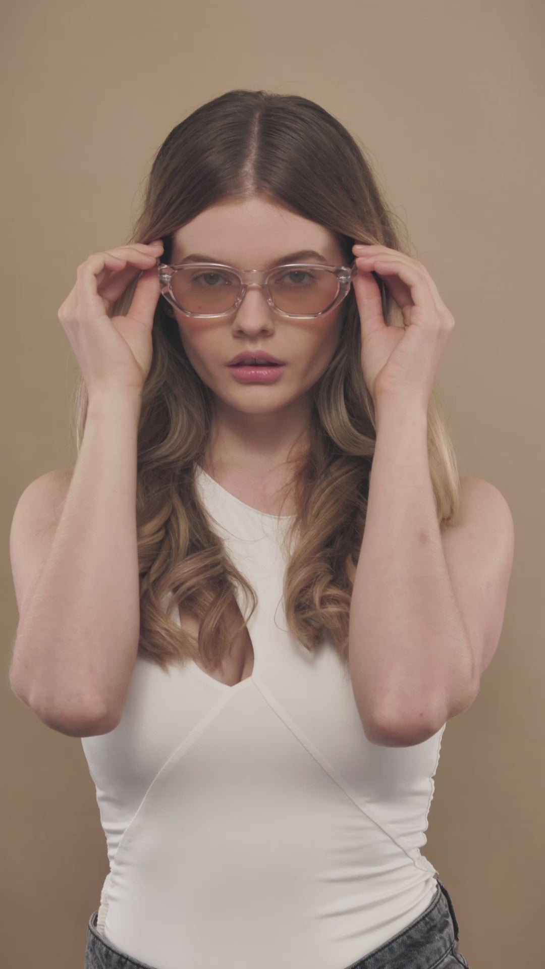 Lifestyle video of a female model wearing Mirach sunglasses in Transparent White. 