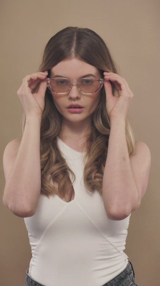Lifestyle video of a female model wearing Mirach sunglasses in Transparent White. 