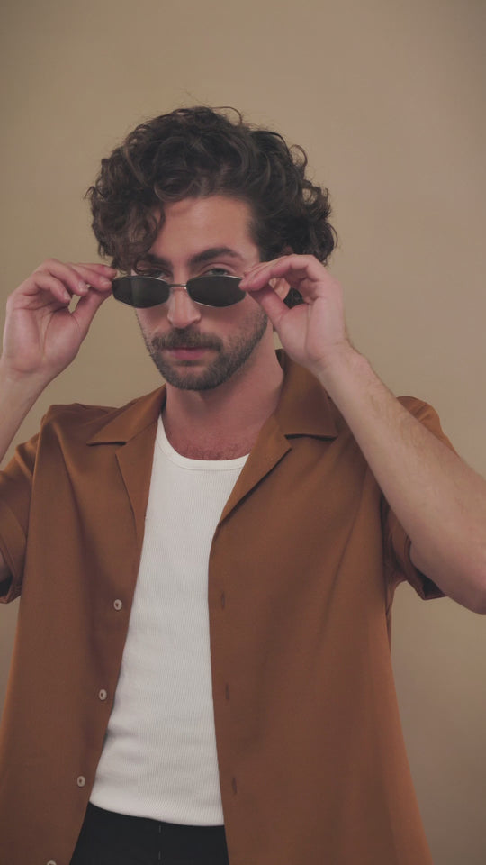 Male model wearing Sirius B Gunmetal sunglasses, showcasing a modern, confident style. 