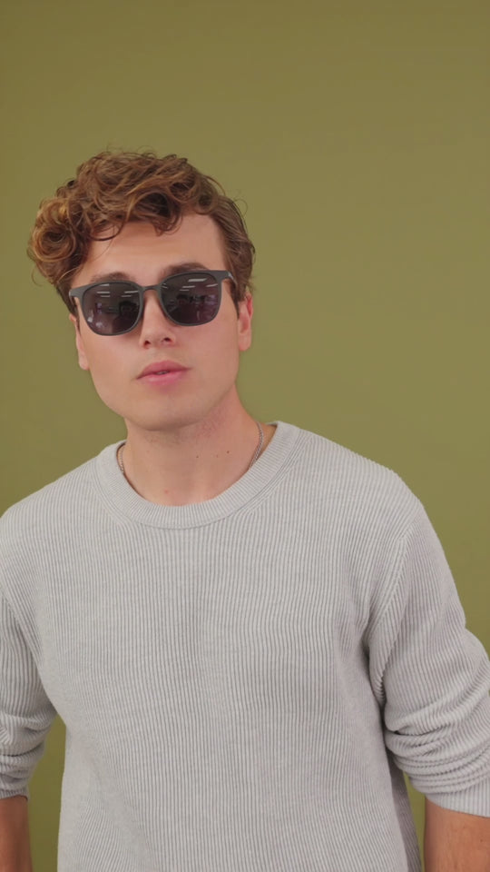 Lifestyle video of a male model wearing Achernar sunglasses in Classic Black. 