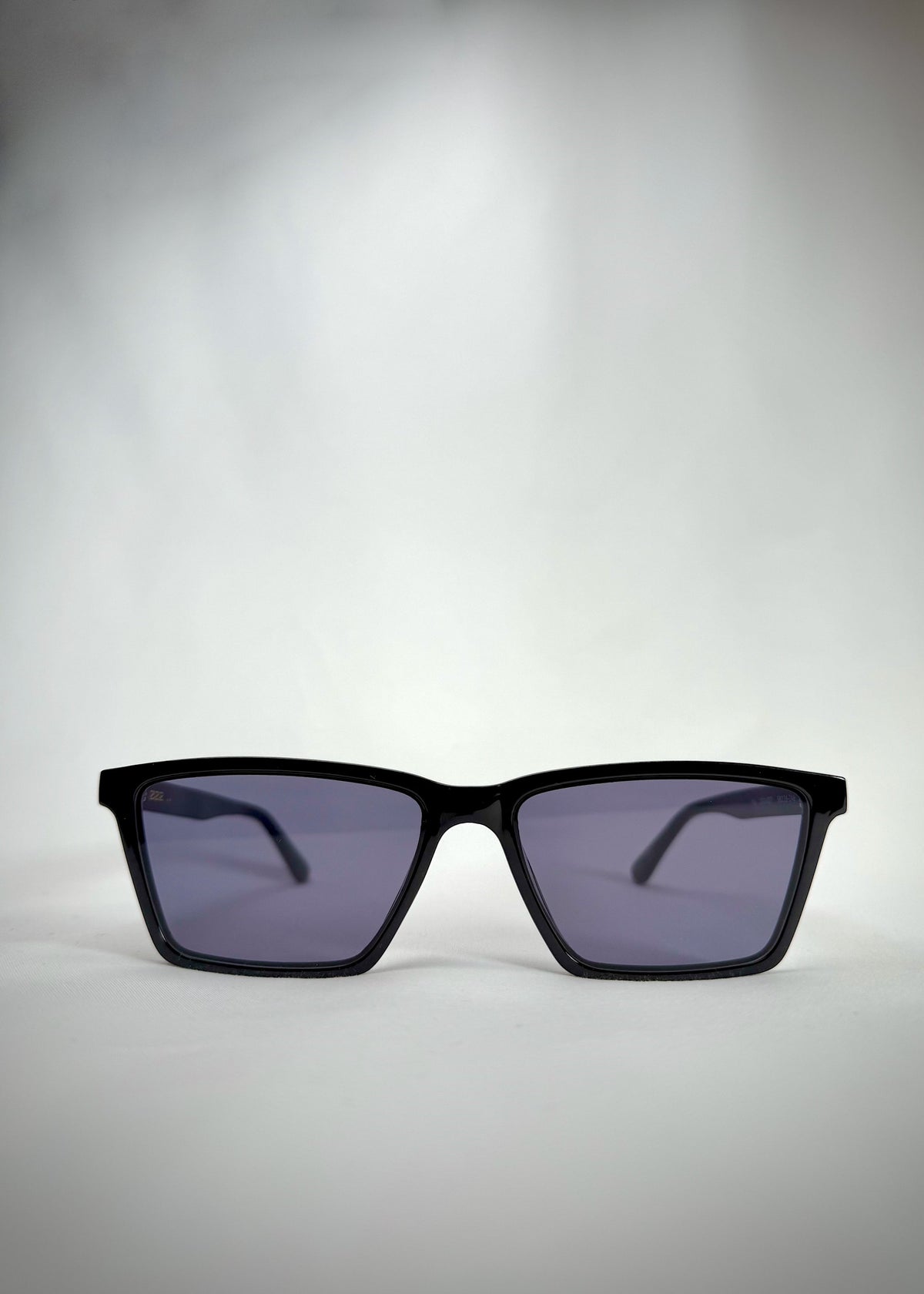 Front view of Rho Black TR90-Acetate prescription sunglasses showcasing the sharp rectangular frame and sleek blue-grey lenses.