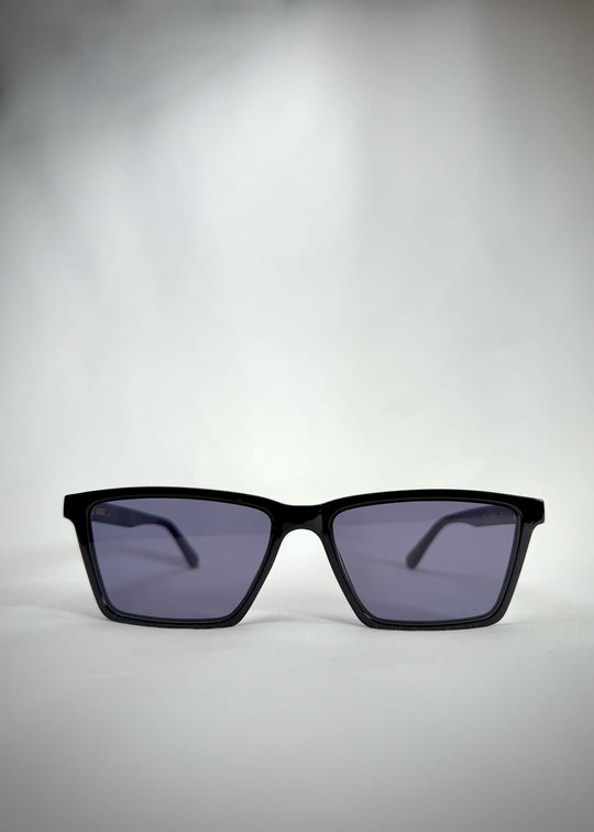 Front view of Rho Black TR90-Acetate prescription sunglasses showcasing the sharp rectangular frame and sleek blue-grey lenses. 