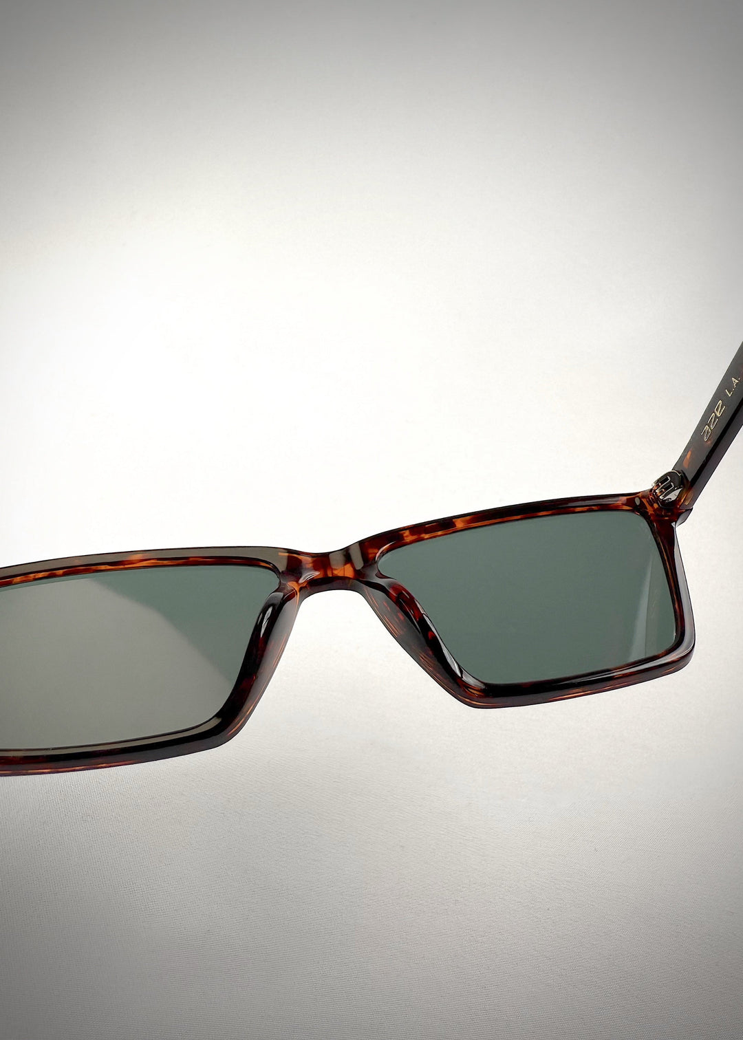 Close-up of Rho Tortoiseshell acetate prescription sunglasses, showcasing the elegant bridge design and rich tortoiseshell frame for a sophisticated look. 