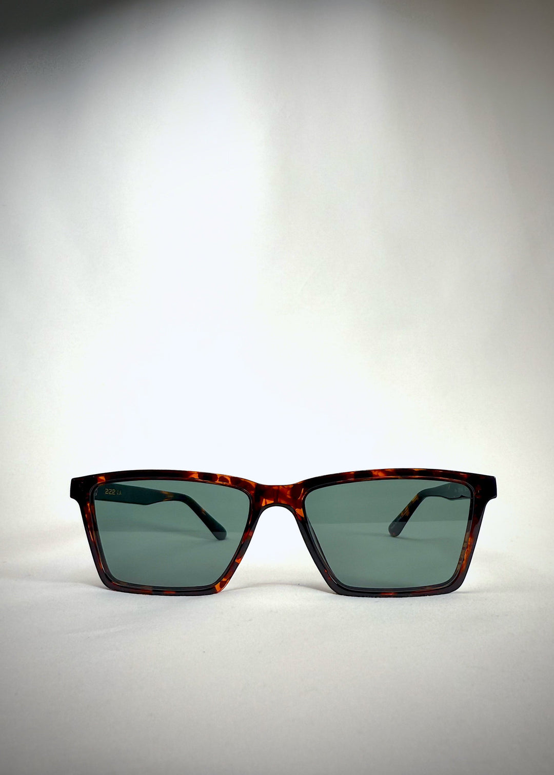 Front view of Rho Tortoiseshell acetate prescription sunglasses with green lenses. 