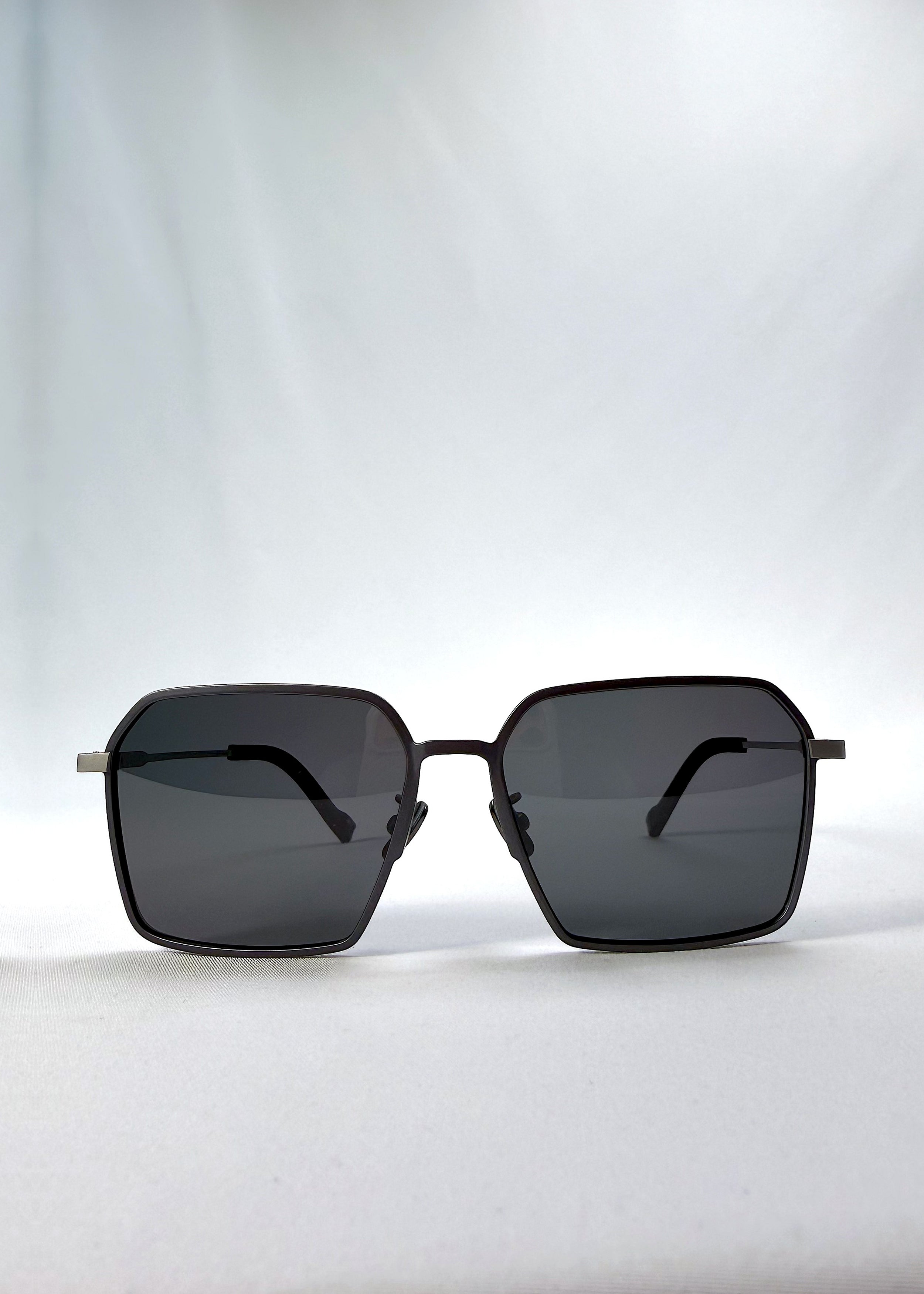 Front view of Rigel sunglasses in Matte Blue, featuring ultra-light titanium frame, geometric lens shape, and polarized lenses, showing the full front silhouette.