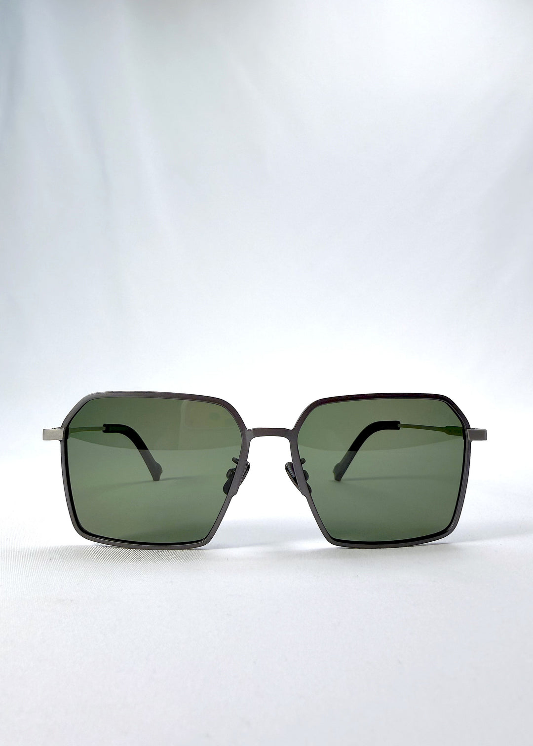 Front view of Rigel sunglasses in Matte Gray, featuring ultra-light titanium frame, geometric lens shape, and polarized lenses, showing the full front silhouette.