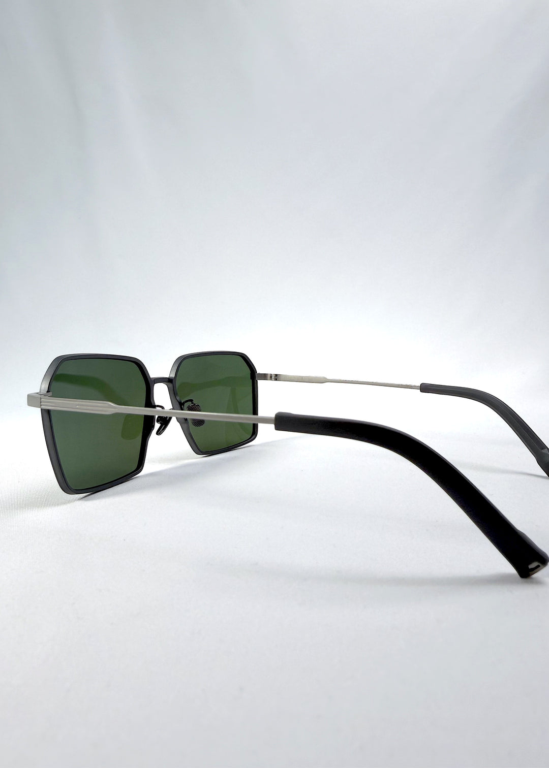 Side-angle view of Rigel sunglasses in Matte Gray, featuring ultra-light titanium frame, geometric lens shape, and polarized lenses, showing the lens shape and temple profile.