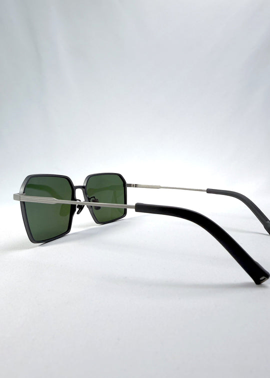 Side-angle view of Rigel sunglasses in Olive Smoke, featuring an ultra-light frame with titanium temples, geometric lens shape, and polarized lenses, showing the lens shape and temple profile. 