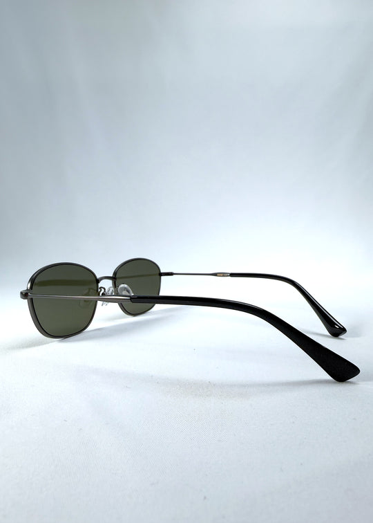 Back-angle view of AZE Selene Line sunglasses in Sage Gunmetal, featuring a slim gunmetal oval metal frame and sage-green lenses, showing the rear frame structure and temple alignment.