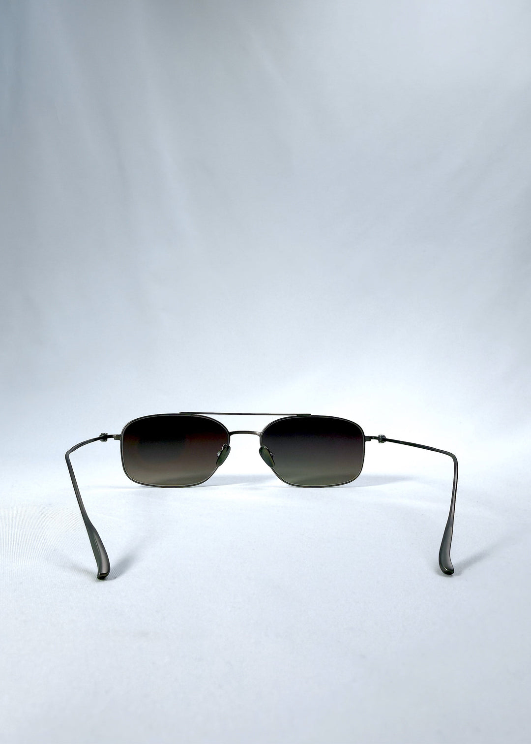 Back view of Seren Arc sunglasses in Mocha Alloy, featuring mocha metal frame and rose-brown lenses, showing the inside frame and open temples. 
