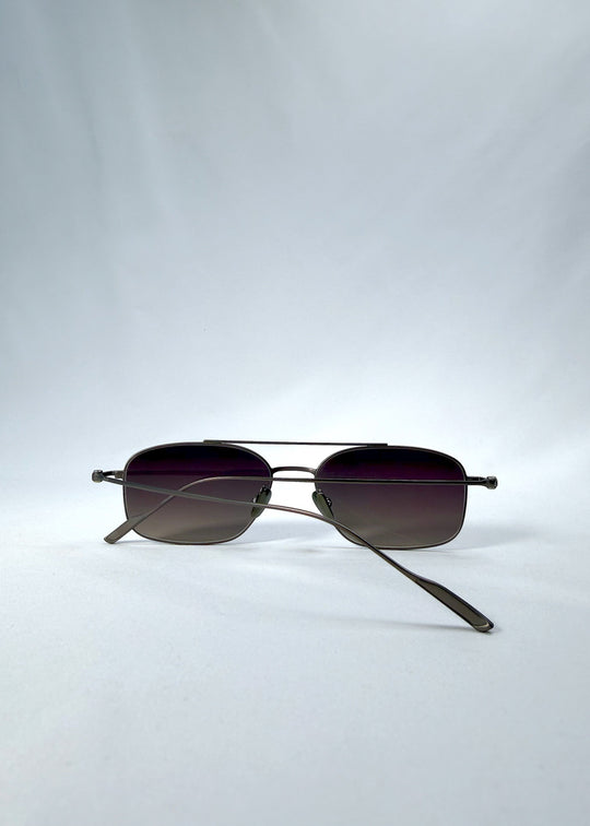 Folded back view of Seren Arc sunglasses in Mocha Alloy, featuring mocha metal frame and rose-brown lenses, showing the folded temples and back structure. 
