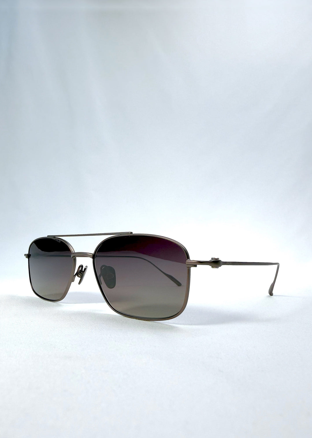 Three-quarter front view of Seren Arc sunglasses in Mocha Alloy, featuring mocha metal frame and rose-brown lenses, showing the front shape and temple profile. 