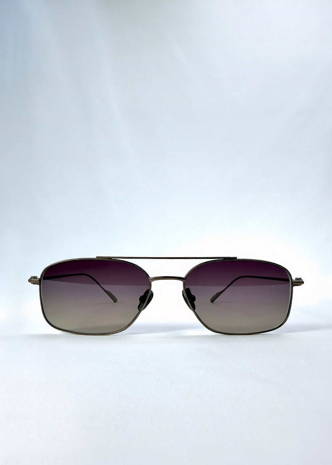 Front view of Seren Arc sunglasses in Mocha Alloy, featuring mocha metal frame and rose-brown lenses, showing the full front silhouette. 