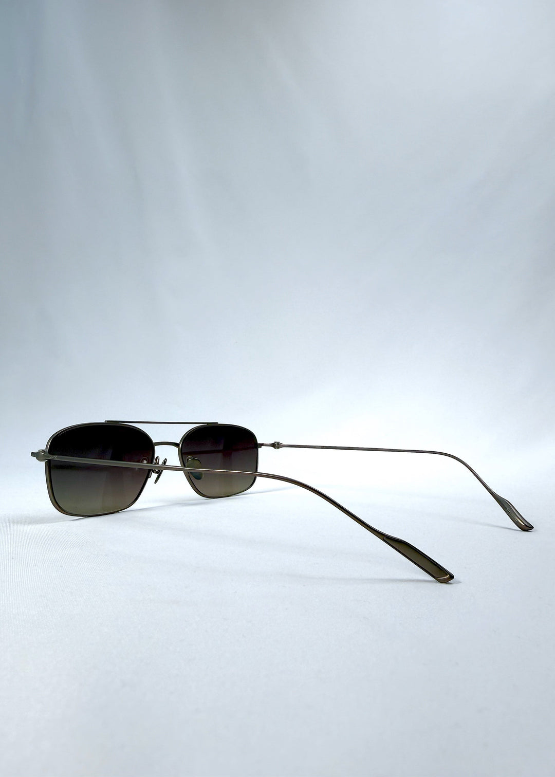 Side-angle view of Seren Arc sunglasses in Mocha Alloy, featuring mocha metal frame and rose-brown lenses, showing the lens shape and side temple profile. 