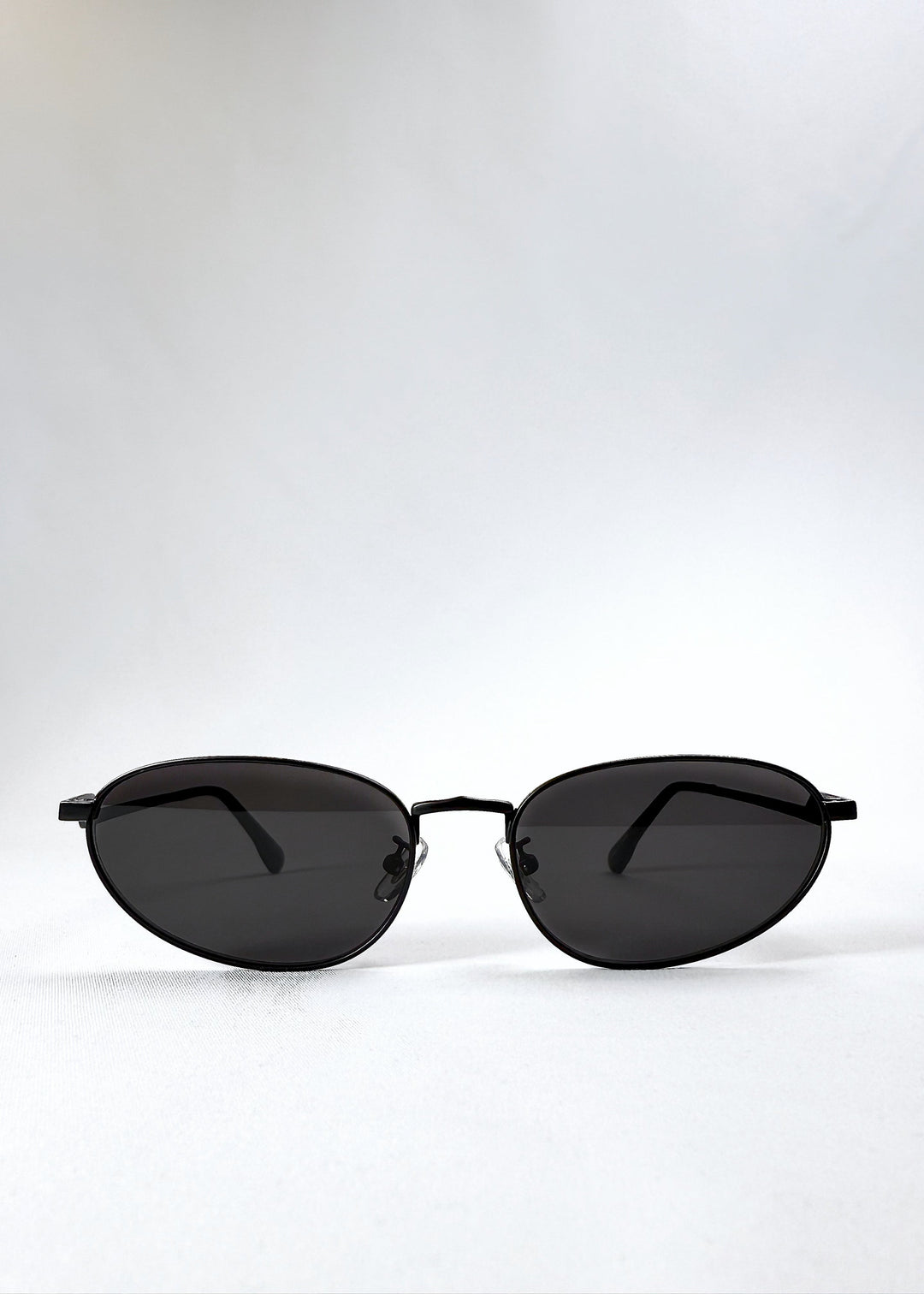 Front view of Lunaris - Shadow Black sunglasses showing the classic aviator silhouette and dark grey lenses. 