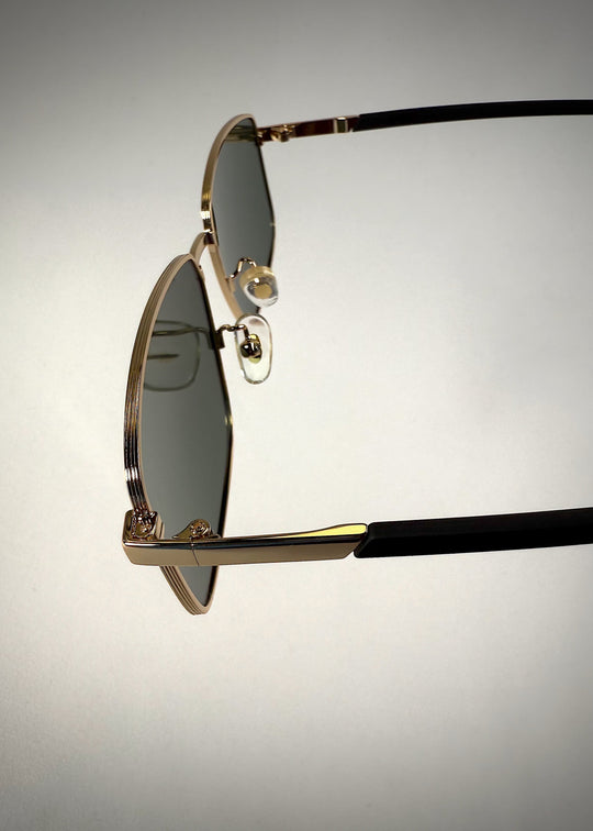 Close-up of Sirius A - Gold sunglasses hinge, highlighting the precision engineering and stainless steel craftsmanship. 