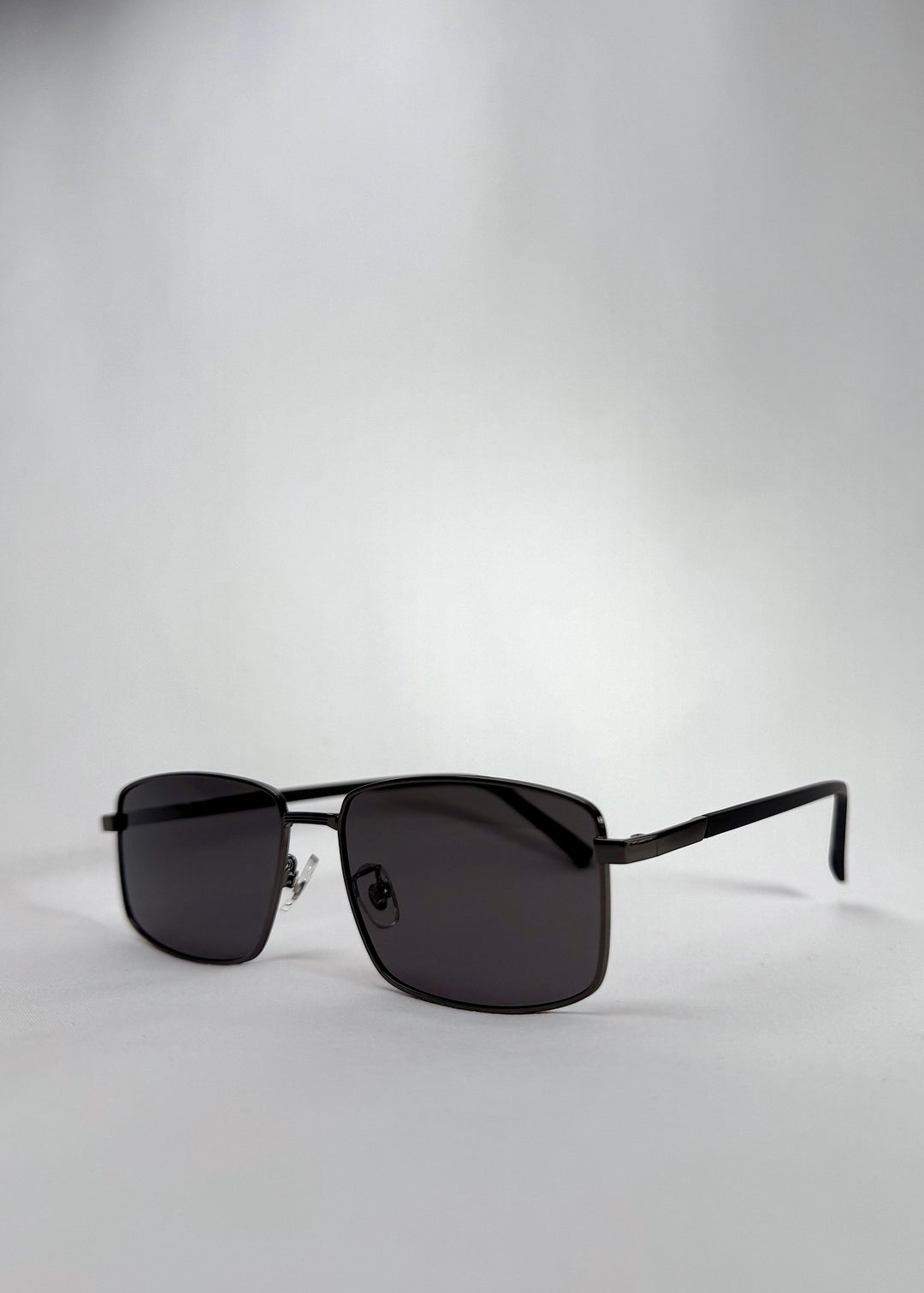 Angled view of Sirius A - Gunmetal Gray sunglasses, emphasizing the slim yet sturdy metal frame and modern rectangular lenses. 