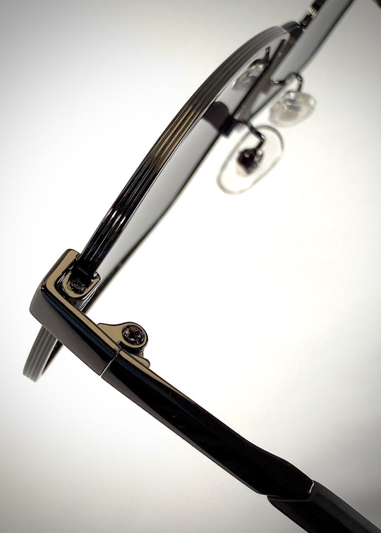 Close-up of Sirius A - Gunmetal Gray sunglasses’ hinge, showcasing the high-quality craftsmanship and sleek metallic finish. 