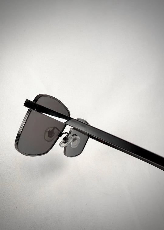 Close-up of Sirius A - Gunmetal Gray sunglasses, highlighting the smooth temple arms and durable frame construction. 