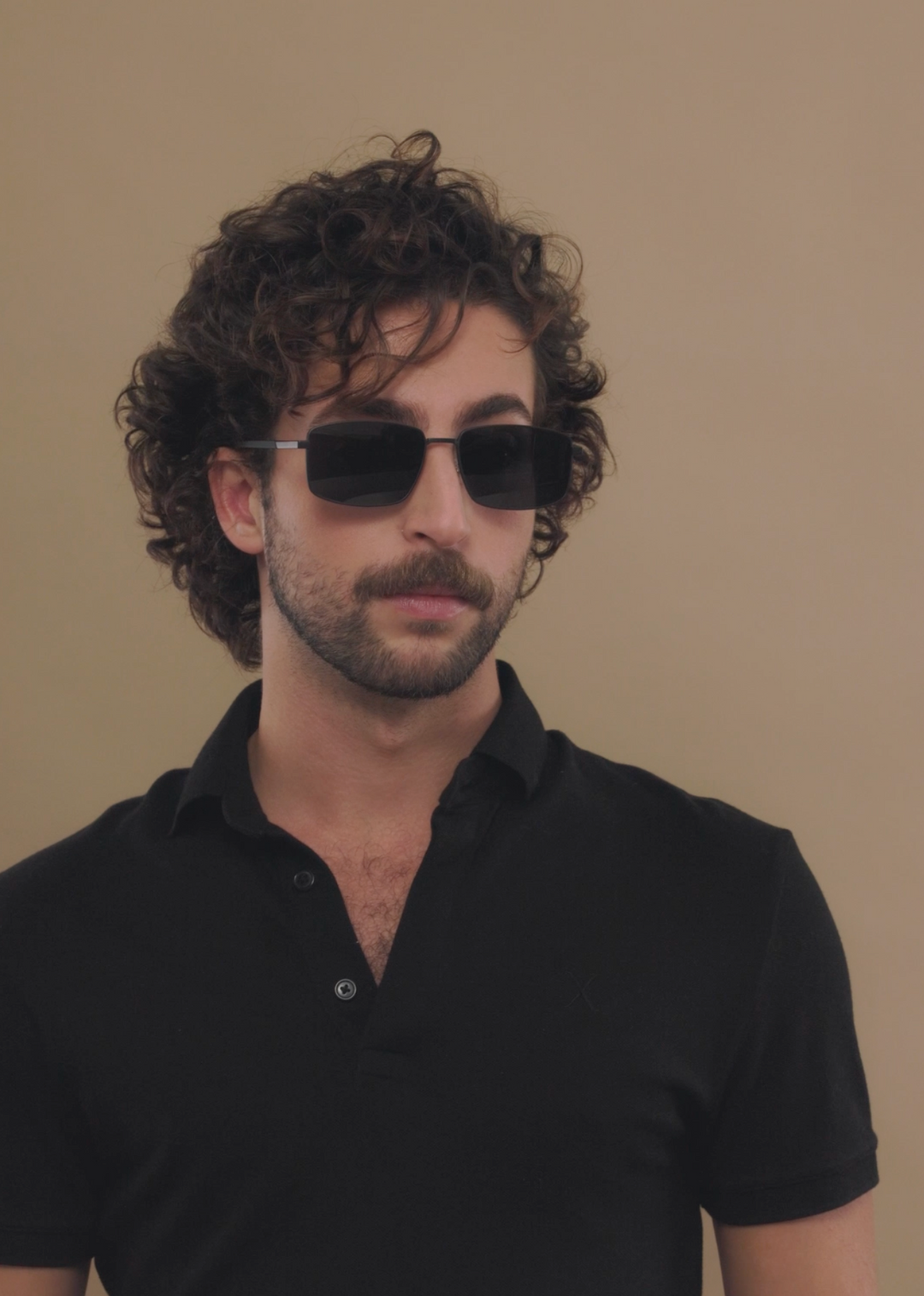 Three-quarter portrait of a male model wearing Sirius A sunglasses in Semi-Matte Black. 