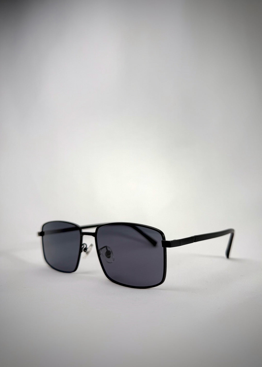 Angled view of Sirius A - Semi-Matte Black sunglasses, showing the smooth matte finish and durable hinge construction. 