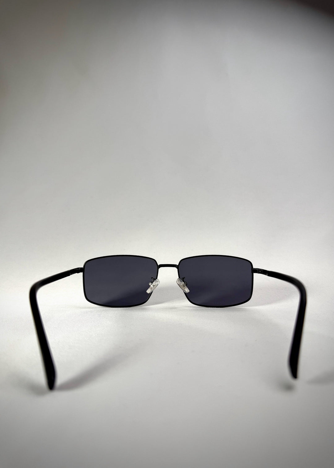 Back view of Sirius A - Semi-Matte Black stainless steel sunglasses, showcasing the adjustable nose pads and ergonomic temple design for a comfortable fit. 
