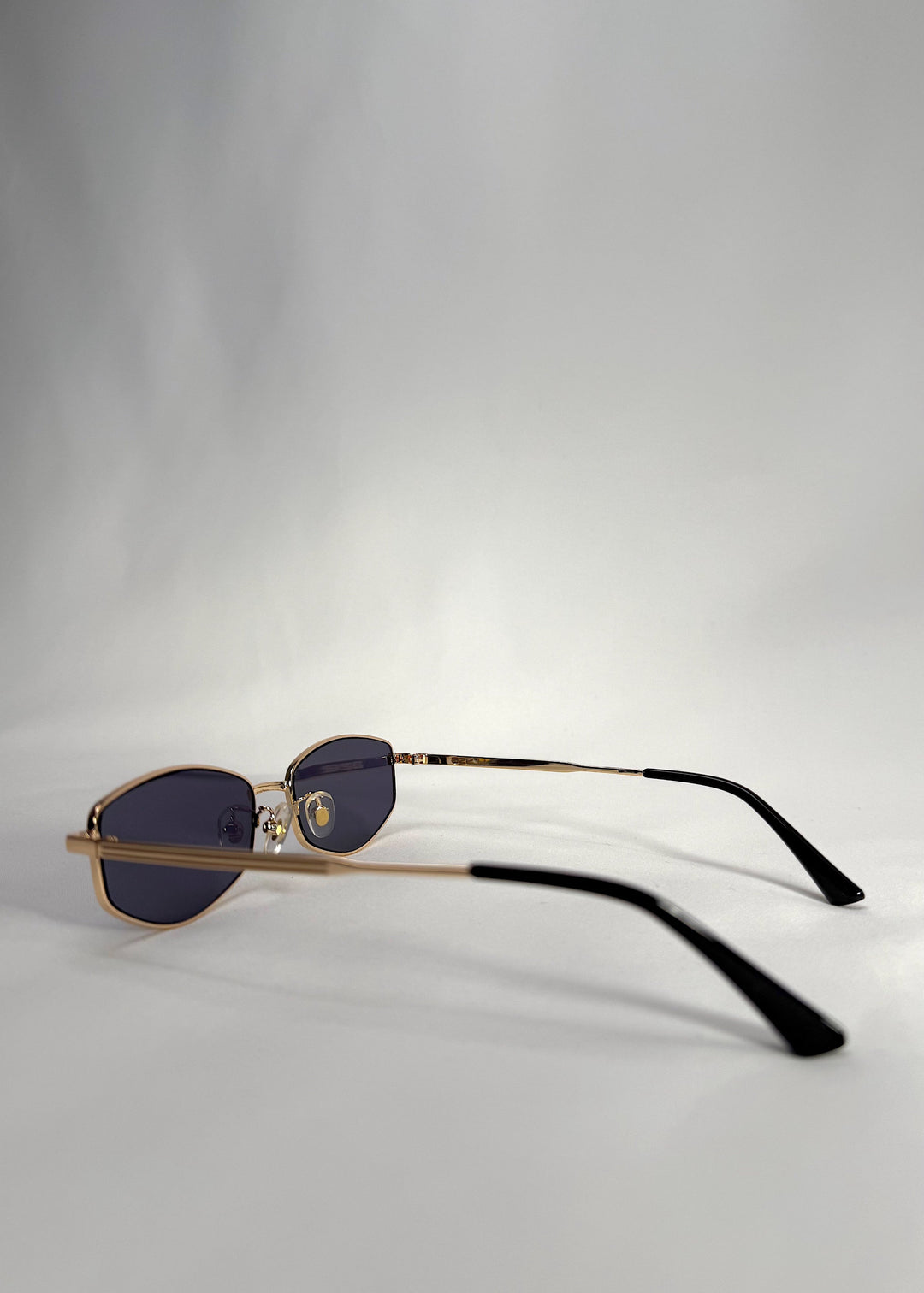 Side view of Sirius B - Gold stainless steel sunglasses, highlighting the elegant gold frame and slim metal temples. 
