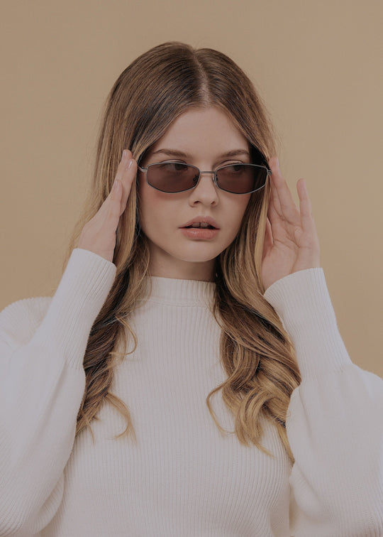 Female model wearing Sirius B Gunmetal Amber sunglasses – Elegant and versatile prescription eyewear. 