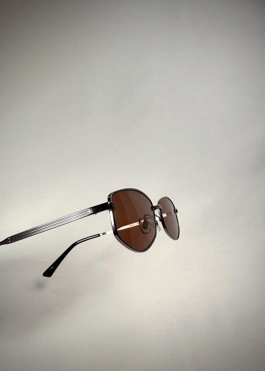 Side-angle view of Sirius B Gunmetal Amber sunglasses – Elegant gunmetal frame with warm amber-tinted lenses, featuring detailed temple design. 