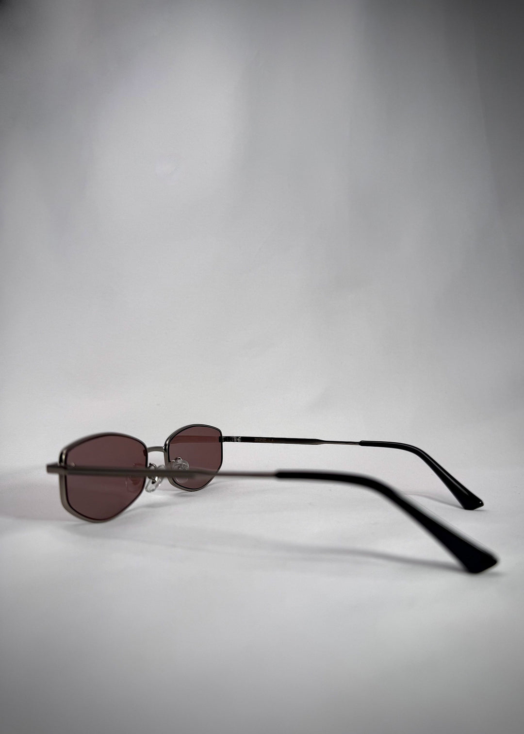 Side view of Sirius B Gunmetal Amber frame – Sleek stainless steel sunglasses with amber-tinted lenses. 