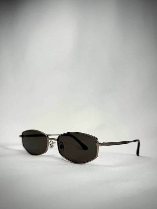 Angled view of Sirius B sunglasses in Gunmetal, showing the stainless-steel frame and gray lenses. 