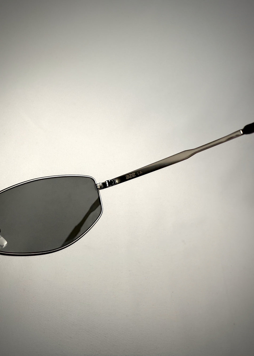 Close-up side view of Sirius B - Matte Black stainless steel sunglasses, showcasing the engraved temple arm branding and sleek metal construction for a refined look. 