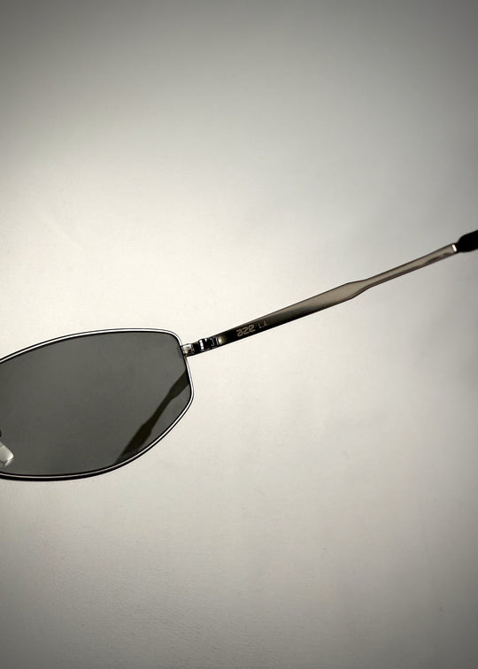 Close-up side view of Sirius B - Matte Black stainless steel sunglasses, showcasing the engraved temple arm branding and sleek metal construction for a refined look. 
