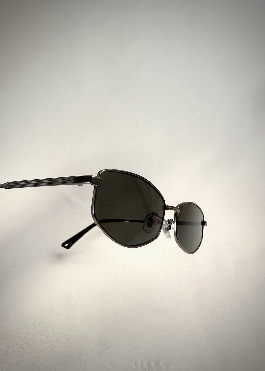 Close-up of the temple and hinge detail on Sirius B - Matte Black sunglasses, showcasing high-quality stainless steel craftsmanship. 